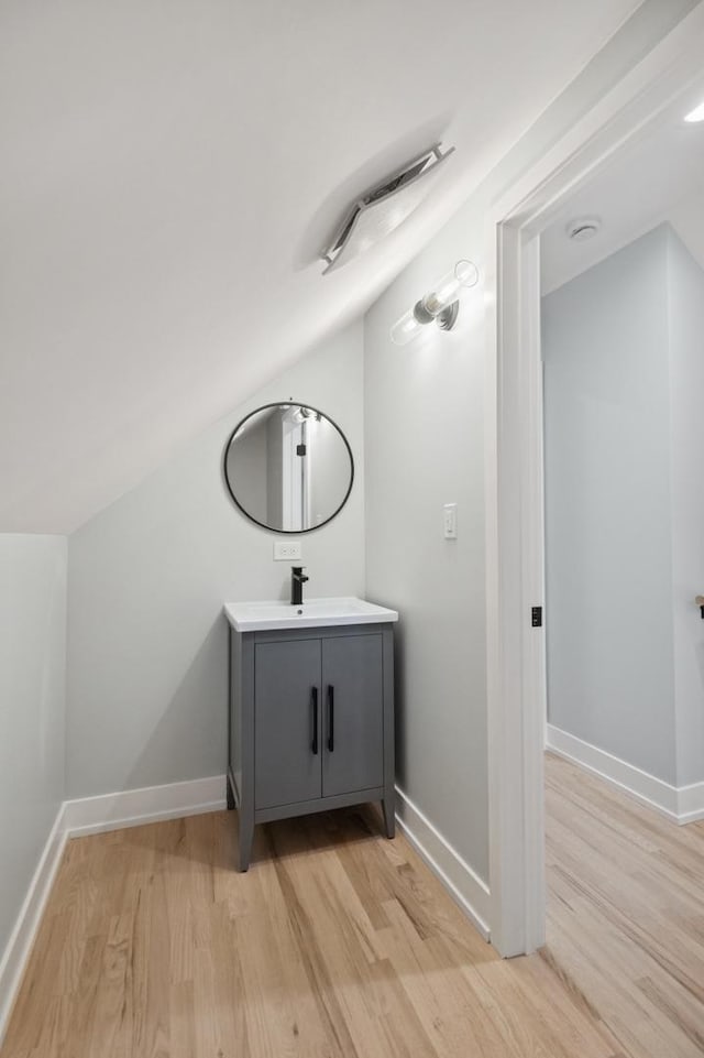 5406 N Mulligan Ave, Chicago, IL 60630 - bathroom featuring wood finished floors, vanity, and lofted ceiling