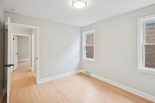5406 N Mulligan Ave, Chicago, IL 60630 - spare room with light wood-style floors, plenty of natural light, and a smoke detector