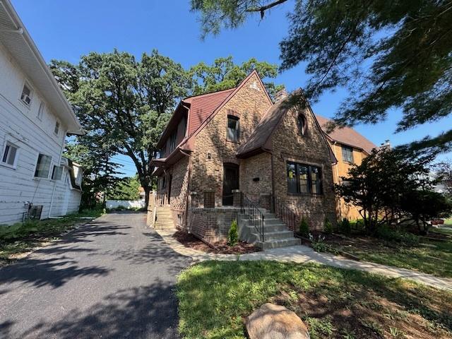 3512 Woodside Ave, Brookfield, IL 60513 - tudor-style house featuring driveway, brick siding, and stone siding