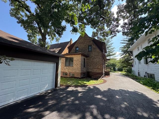 3512 Woodside Ave, Brookfield, IL 60513 - view of side of home with a garage, driveway, and brick siding