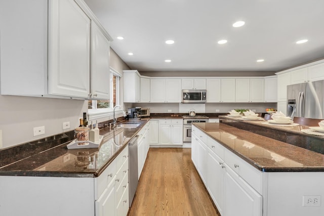 7509 Bittersweet Dr, Gurnee, IL 60031 - kitchen featuring appliances with stainless steel finishes, white cabinetry, recessed lighting, a kitchen island, and light wood-type flooring
