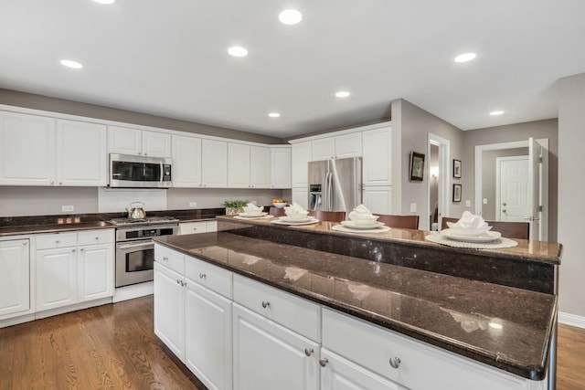 7509 Bittersweet Dr, Gurnee, IL 60031 - kitchen featuring appliances with stainless steel finishes, white cabinets, dark wood-style floors, and recessed lighting