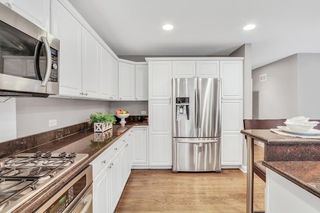 7509 Bittersweet Dr, Gurnee, IL 60031 - kitchen featuring appliances with stainless steel finishes, recessed lighting, white cabinetry, light wood-style floors, and dark stone counters