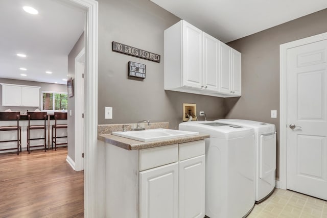 7509 Bittersweet Dr, Gurnee, IL 60031 - laundry room with independent washer and dryer, cabinet space, recessed lighting, and light wood-style flooring