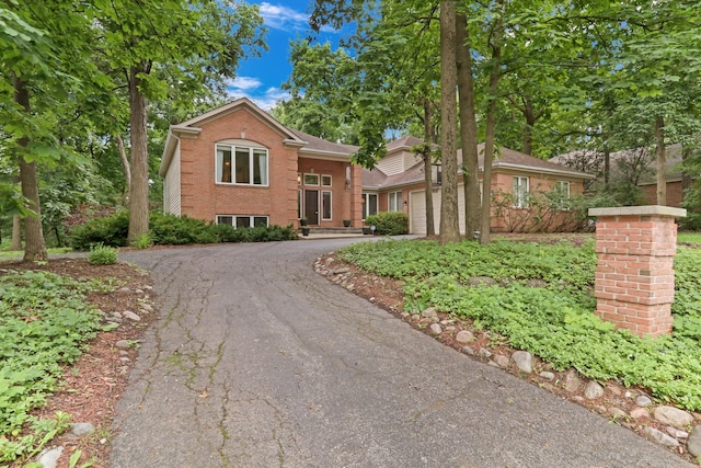 7509 Bittersweet Dr, Gurnee, IL 60031 - view of front of property with asphalt driveway, brick siding, and a garage