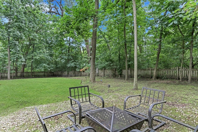 7509 Bittersweet Dr, Gurnee, IL 60031 - fenced backyard with a fire pit and view of scattered trees