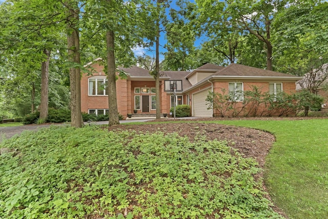 7509 Bittersweet Dr, Gurnee, IL 60031 - view of front of house featuring a garage, brick siding, driveway, and a front lawn