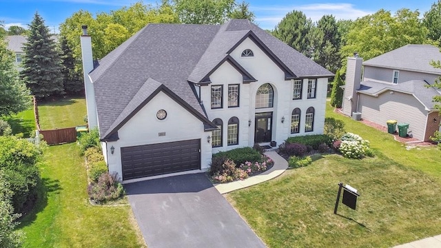 2011 Gleneagle Dr, Plainfield, IL 60586 - french provincial home with asphalt driveway, a chimney, roof with shingles, and a garage
