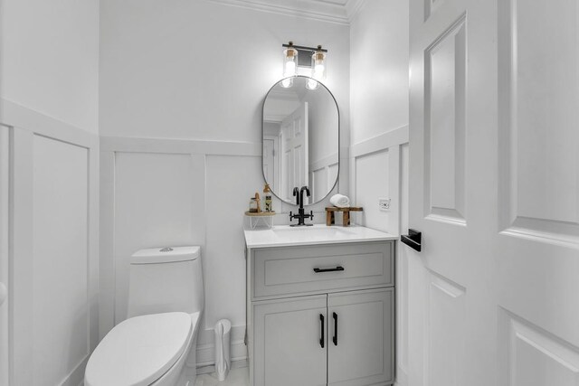 2011 Gleneagle Dr, Plainfield, IL 60586 - half bathroom featuring a decorative wall, crown molding, vanity, and a wainscoted wall