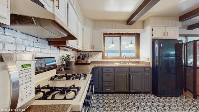 265 N Shaddle Ave, Mundelein, IL 60060 - kitchen with white range with gas cooktop, freestanding refrigerator, under cabinet range hood, gray cabinets, and healthy amount of natural light