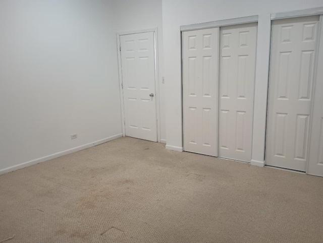 2236 W Monroe St, Chicago, IL 60612 - unfurnished bedroom featuring light carpet and multiple closets