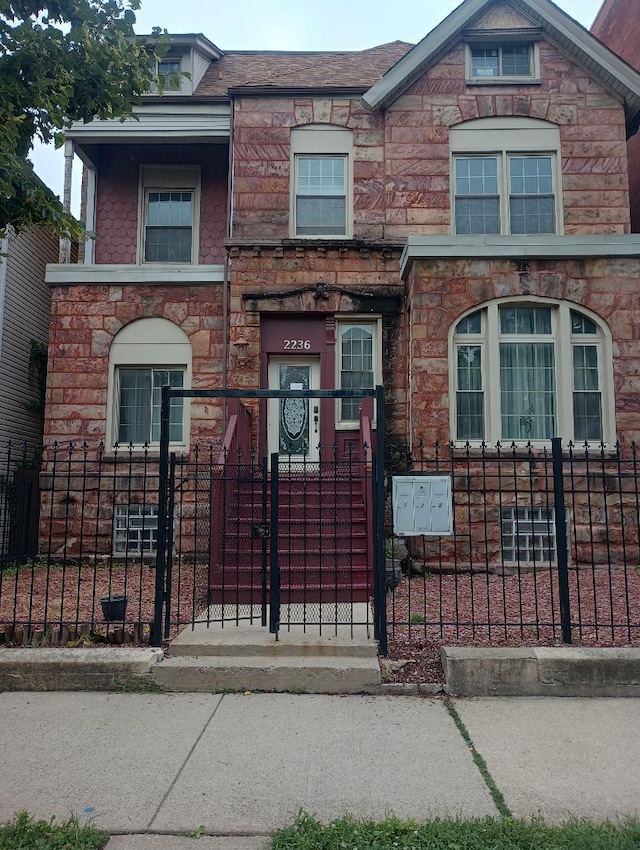 2236 W Monroe St, Chicago, IL 60612 - townhome / multi-family property featuring stone siding and a fenced front yard