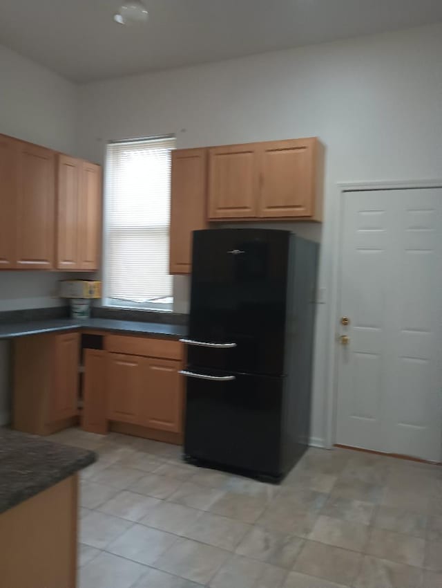 2236 W Monroe St, Chicago, IL 60612 - kitchen featuring freestanding refrigerator, dark countertops, and light tile patterned floors