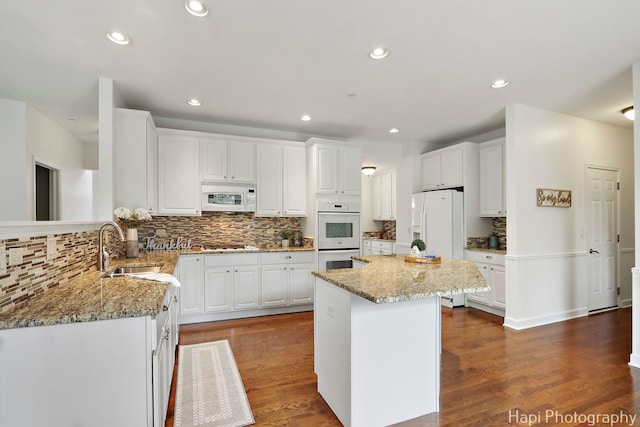 10174 Hopkins St, Huntley, IL 60142 - kitchen with white appliances, white cabinets, light stone countertops, decorative backsplash, and recessed lighting