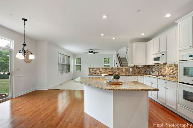 10174 Hopkins St, Huntley, IL 60142 - kitchen with white appliances, backsplash, recessed lighting, white cabinetry, and decorative light fixtures