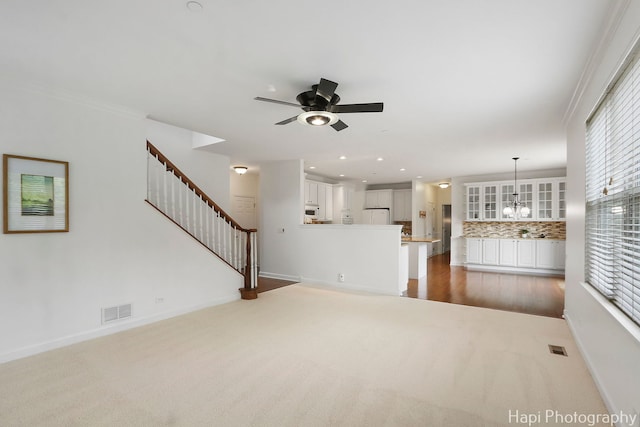 10174 Hopkins St, Huntley, IL 60142 - unfurnished living room with carpet floors, ceiling fan, stairs, recessed lighting, and a chandelier