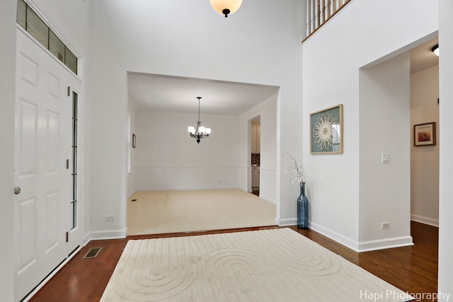 10174 Hopkins St, Huntley, IL 60142 - entrance foyer with dark wood-style flooring, a chandelier, and a high ceiling
