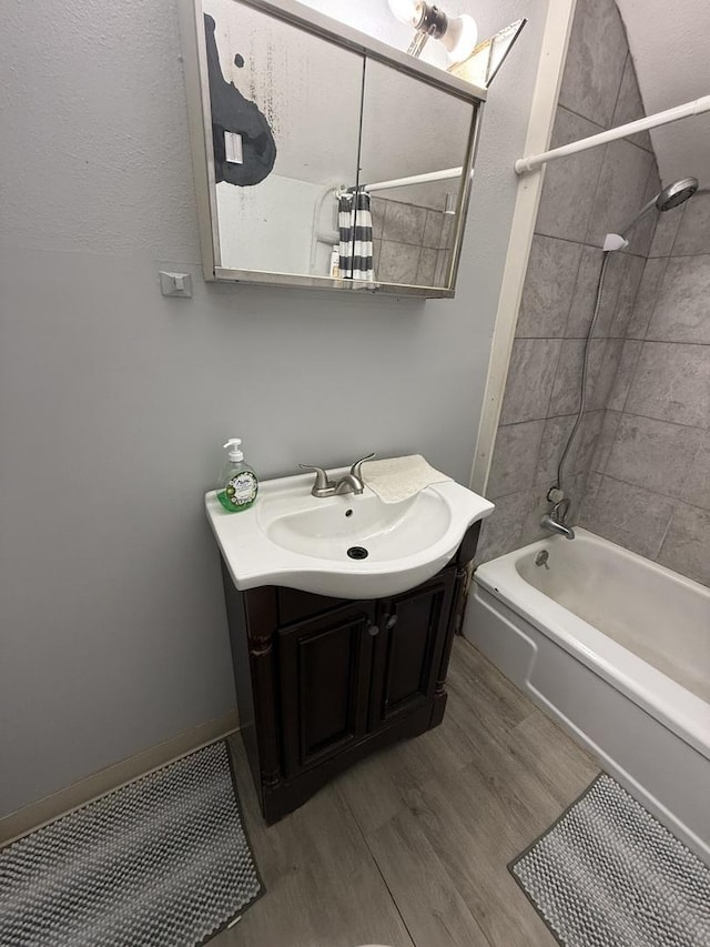 1250 Corbin St, Rockford, IL 61102 - bathroom with vanity,  shower combination, and wood finished floors
