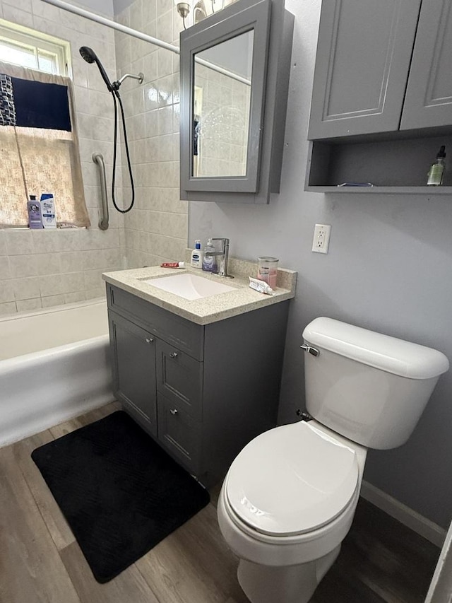 1250 Corbin St, Rockford, IL 61102 - full bath with vanity, wood finished floors, and bathing tub / shower combination