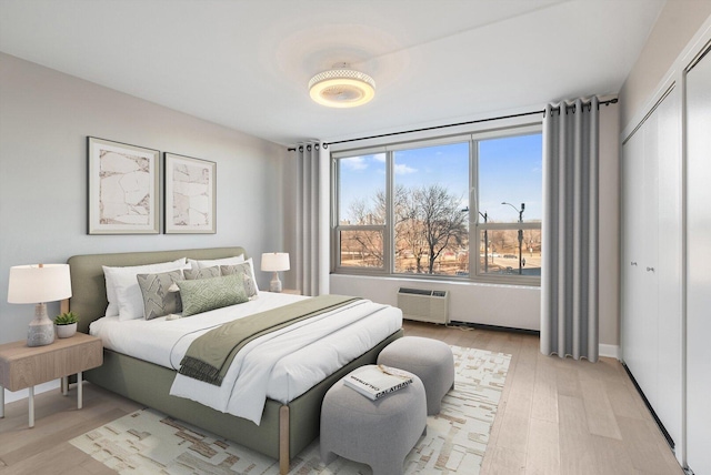 1550 N Lake Shore Dr Unit 2A, Chicago, IL 60610 - bedroom featuring light wood-type flooring, a closet, and an AC wall unit