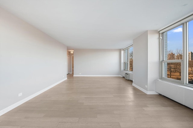 1550 N Lake Shore Dr Unit 2A, Chicago, IL 60610 - unfurnished room featuring plenty of natural light, light wood-style floors, and radiator