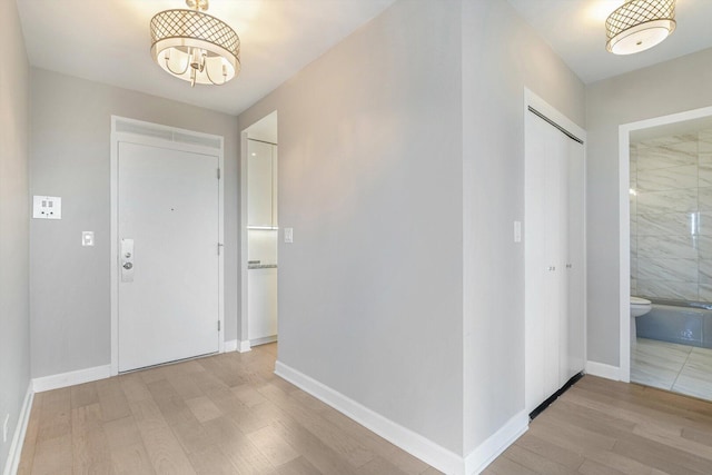 1550 N Lake Shore Dr Unit 2A, Chicago, IL 60610 - foyer entrance with light wood-type flooring and a chandelier