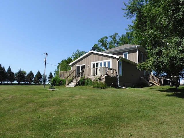 4256 W Egan Rd, Leaf River, IL 61047 - view of front facade with a deck, a front lawn, and stairs