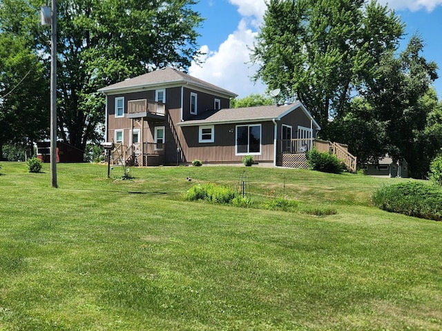4256 W Egan Rd, Leaf River, IL 61047 - rear view of property featuring a balcony and a lawn