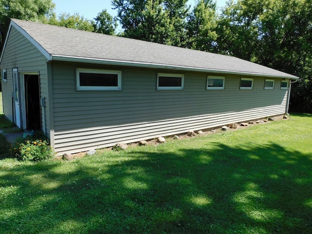 4256 W Egan Rd, Leaf River, IL 61047 - view of side of property featuring a yard and roof with shingles