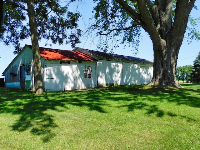 4256 W Egan Rd, Leaf River, IL 61047 - view of side of property with a yard, an outdoor structure, an outbuilding, and a metal roof