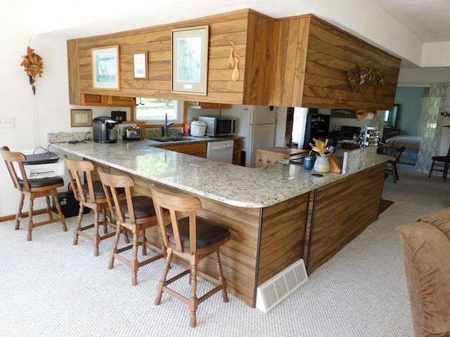 4256 W Egan Rd, Leaf River, IL 61047 - kitchen featuring white appliances, carpet flooring, a peninsula, and light stone countertops