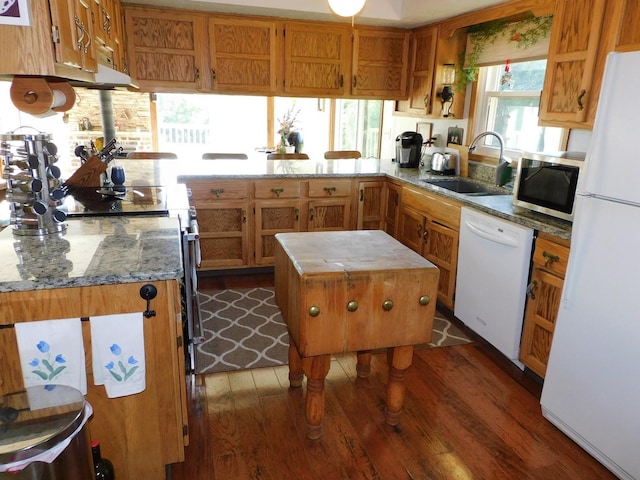 4256 W Egan Rd, Leaf River, IL 61047 - kitchen featuring white appliances, dark wood-type flooring, a peninsula, brown cabinetry, and light stone countertops