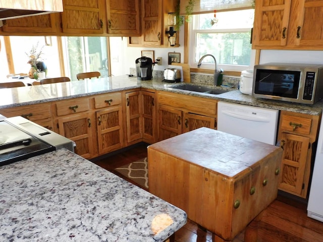 4256 W Egan Rd, Leaf River, IL 61047 - kitchen featuring stainless steel microwave, dishwasher, dark wood-style floors, a peninsula, and light stone countertops