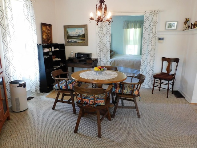 4256 W Egan Rd, Leaf River, IL 61047 - dining area with a chandelier and light carpet