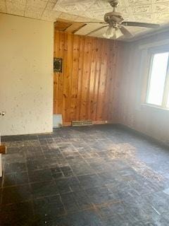 26158 W Reed St, Ingleside, IL 60041 - empty room with wooden walls, a ceiling fan, and an ornate ceiling