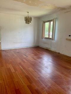 26158 W Reed St, Ingleside, IL 60041 - spare room with a chandelier and wood finished floors