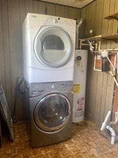 26158 W Reed St, Ingleside, IL 60041 - laundry area with stacked washer / dryer, brick patterned floors, gas water heater, and wooden walls