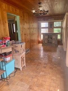 26158 W Reed St, Ingleside, IL 60041 - unfurnished living room with wooden walls, a chandelier, and a fireplace