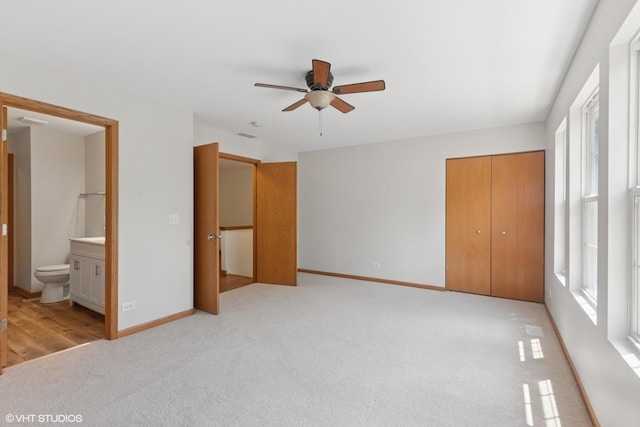 133 Springbrook Trl S, Oswego, IL 60543 - unfurnished bedroom featuring multiple windows, light carpet, ensuite bathroom, and a closet