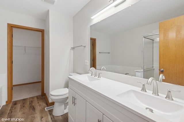 133 Springbrook Trl S, Oswego, IL 60543 - full bath featuring wood finished floors, a stall shower, double vanity, and a spacious closet