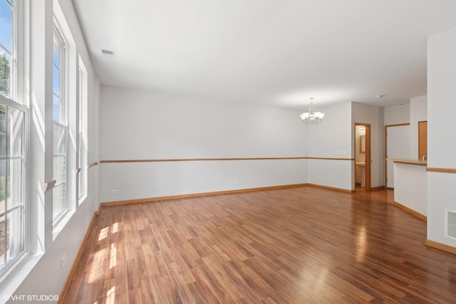 133 Springbrook Trl S, Oswego, IL 60543 - spare room with a chandelier and wood finished floors