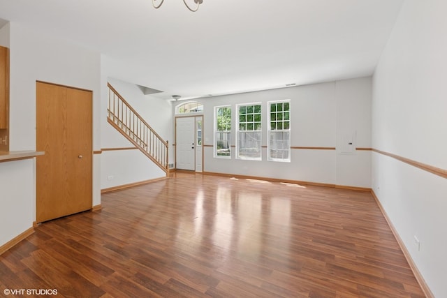 133 Springbrook Trl S, Oswego, IL 60543 - unfurnished living room with stairway and wood finished floors