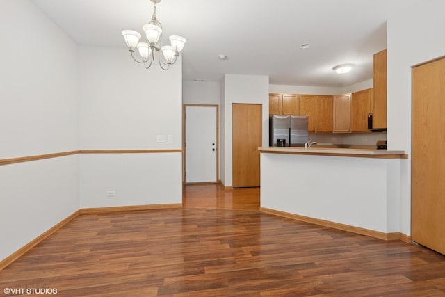 133 Springbrook Trl S, Oswego, IL 60543 - kitchen with stainless steel refrigerator with ice dispenser, wood finished floors, a chandelier, pendant lighting, and light countertops