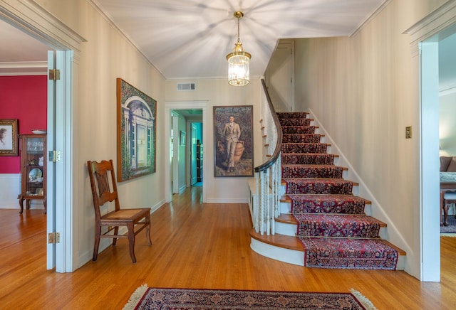 1286 W Stephenson St, Freeport, IL 61032 - entrance foyer with wood finished floors, stairs, a chandelier, and crown molding
