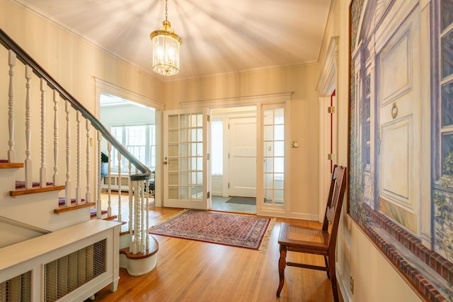 1286 W Stephenson St, Freeport, IL 61032 - entryway featuring a chandelier, wood finished floors, stairs, radiator, and crown molding
