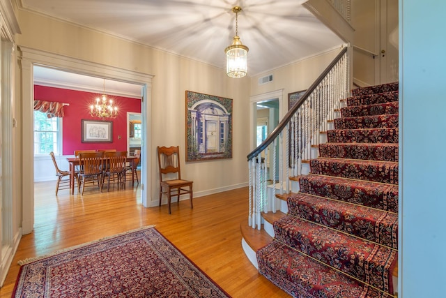 1286 W Stephenson St, Freeport, IL 61032 - entryway with a chandelier, stairs, ornamental molding, and light wood-type flooring
