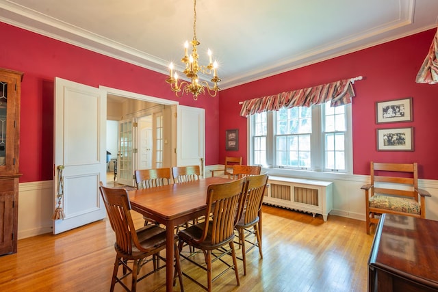 1286 W Stephenson St, Freeport, IL 61032 - dining room with radiator, a chandelier, light wood-type flooring, and crown molding