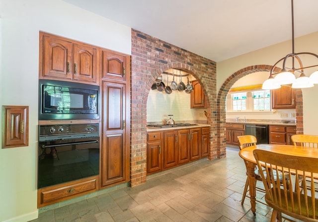 1286 W Stephenson St, Freeport, IL 61032 - kitchen featuring black appliances, light countertops, brown cabinetry, and a chandelier