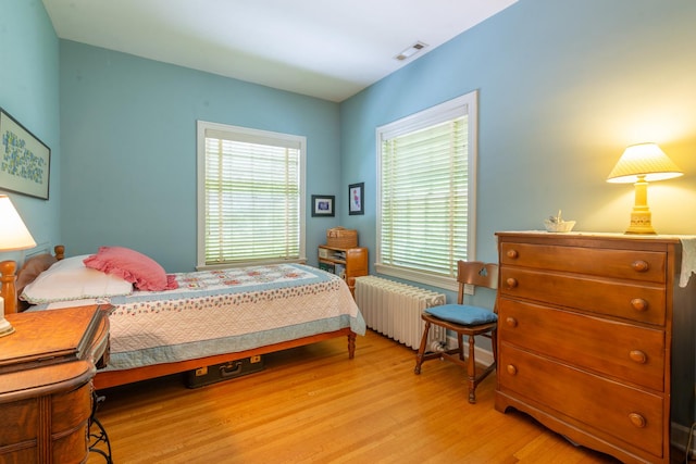 1286 W Stephenson St, Freeport, IL 61032 - bedroom with radiator and light wood-style flooring