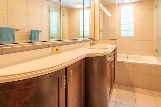 1286 W Stephenson St, Freeport, IL 61032 - full bathroom featuring vanity, tiled bath, tile patterned floors, a tile shower, and tile walls
